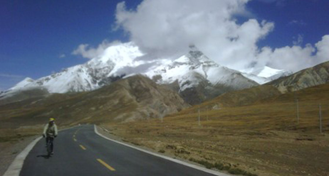 Greg biking along the road of Mt. Everest