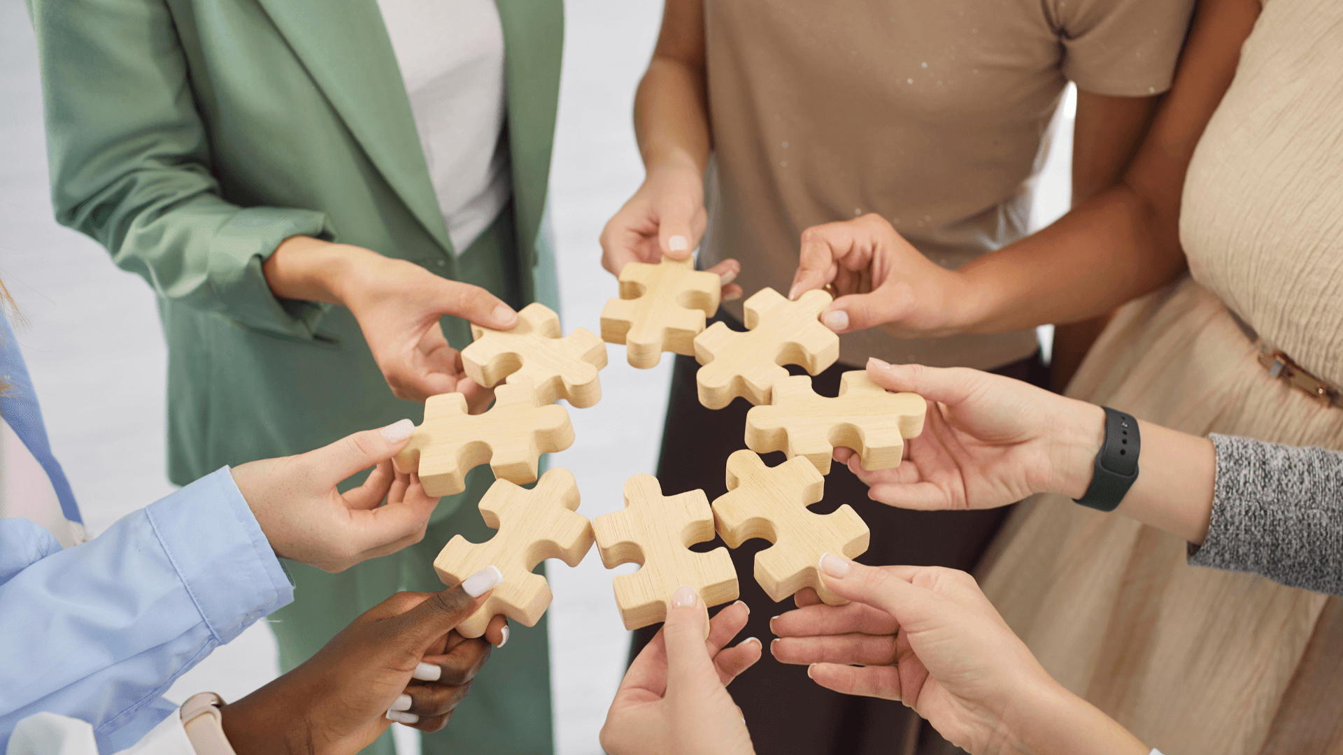 A collaborative workshop session where a consultant is working with a business team to map out processes on a transparent glass board using colourful sticky notes. The scene is candid and professional, with a shallow depth of field focusing on the team's engagement.