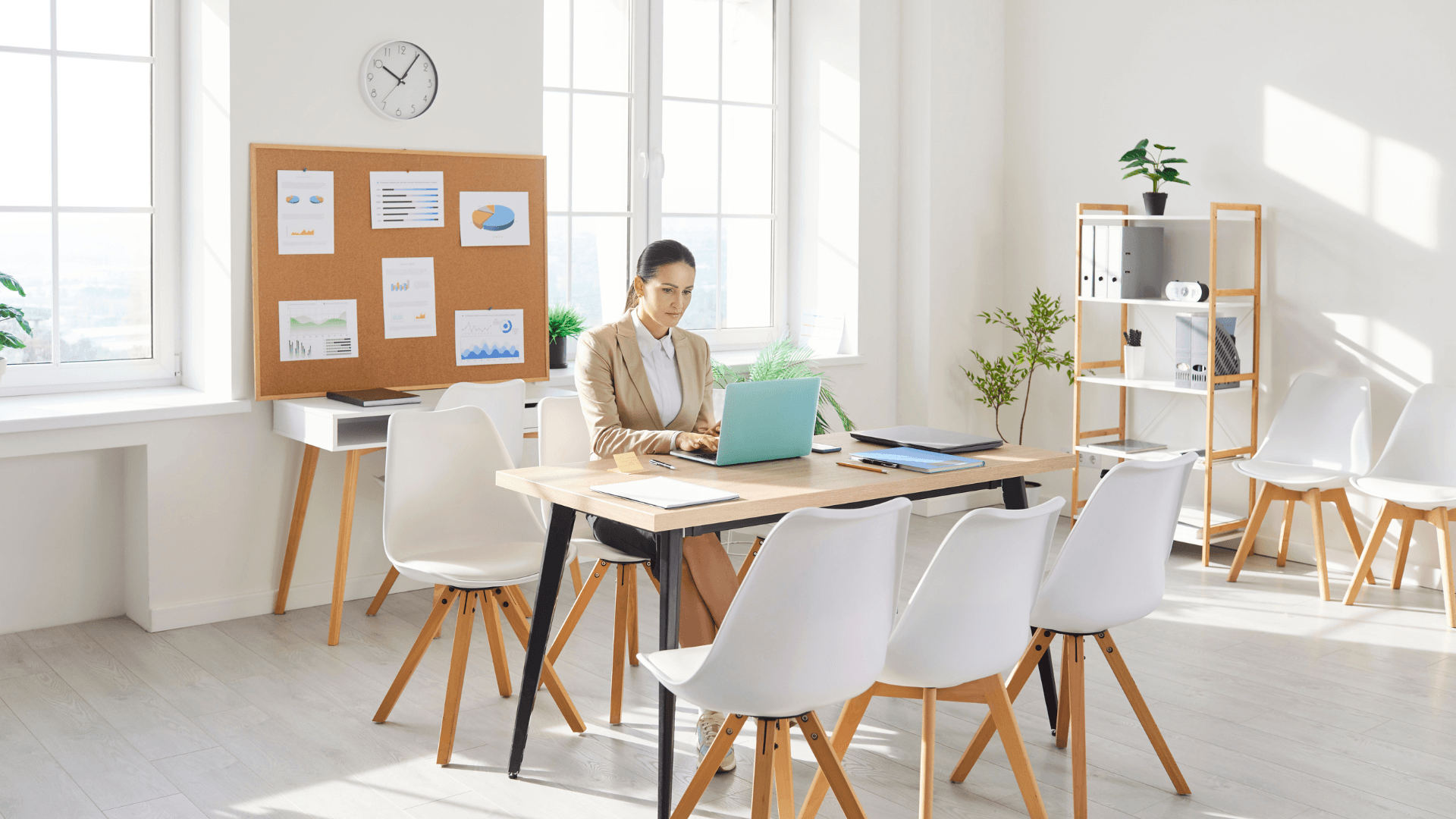 A warm, candid photo of Greg Gunther and the Your Business Momentum team in a collaborative strategy session. The lighting is soft and natural, showing a group of professionals working together around a table with laptops and notes, embodying the 