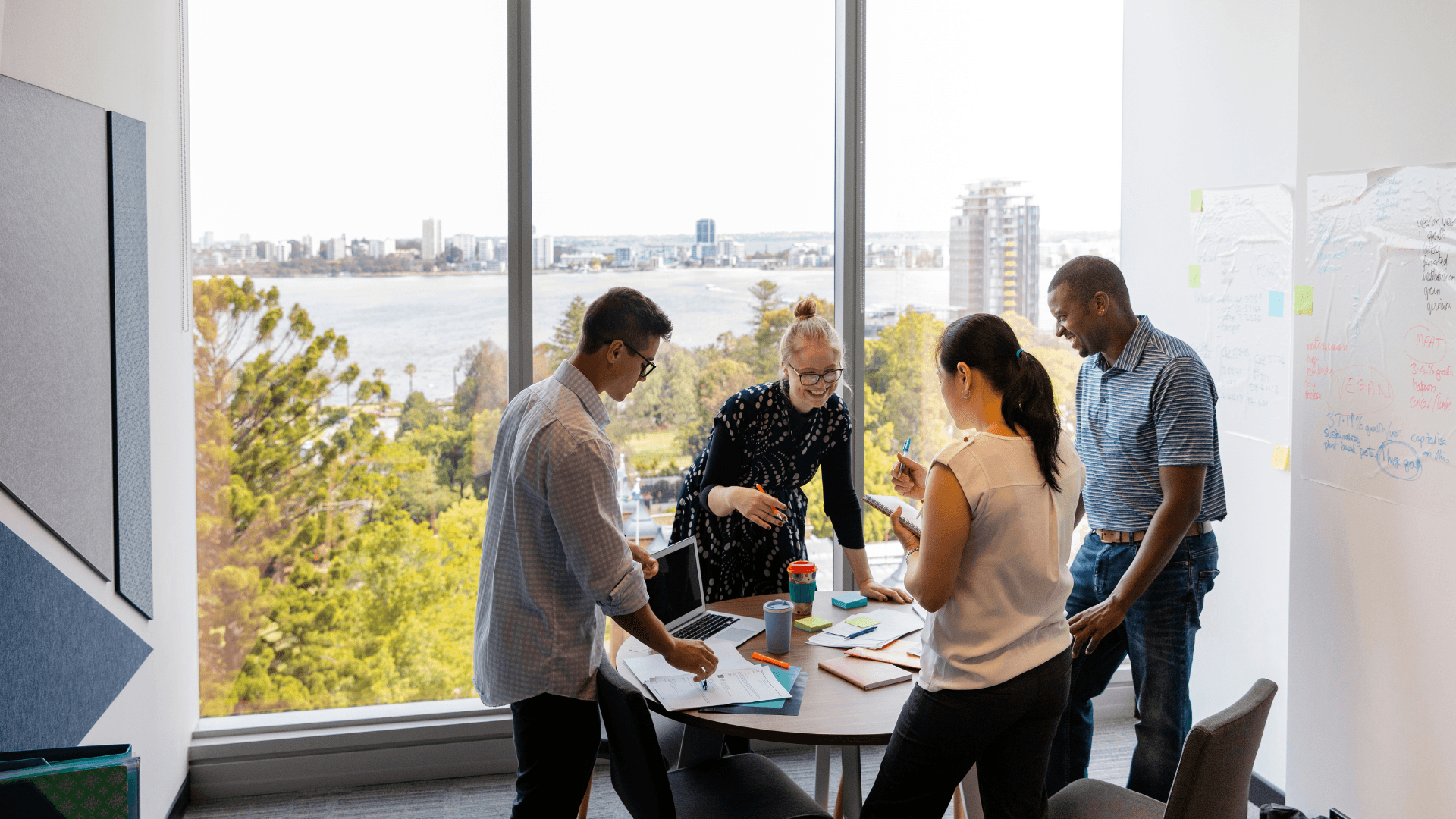 A diverse team collaborates in a bright, modern boardroom